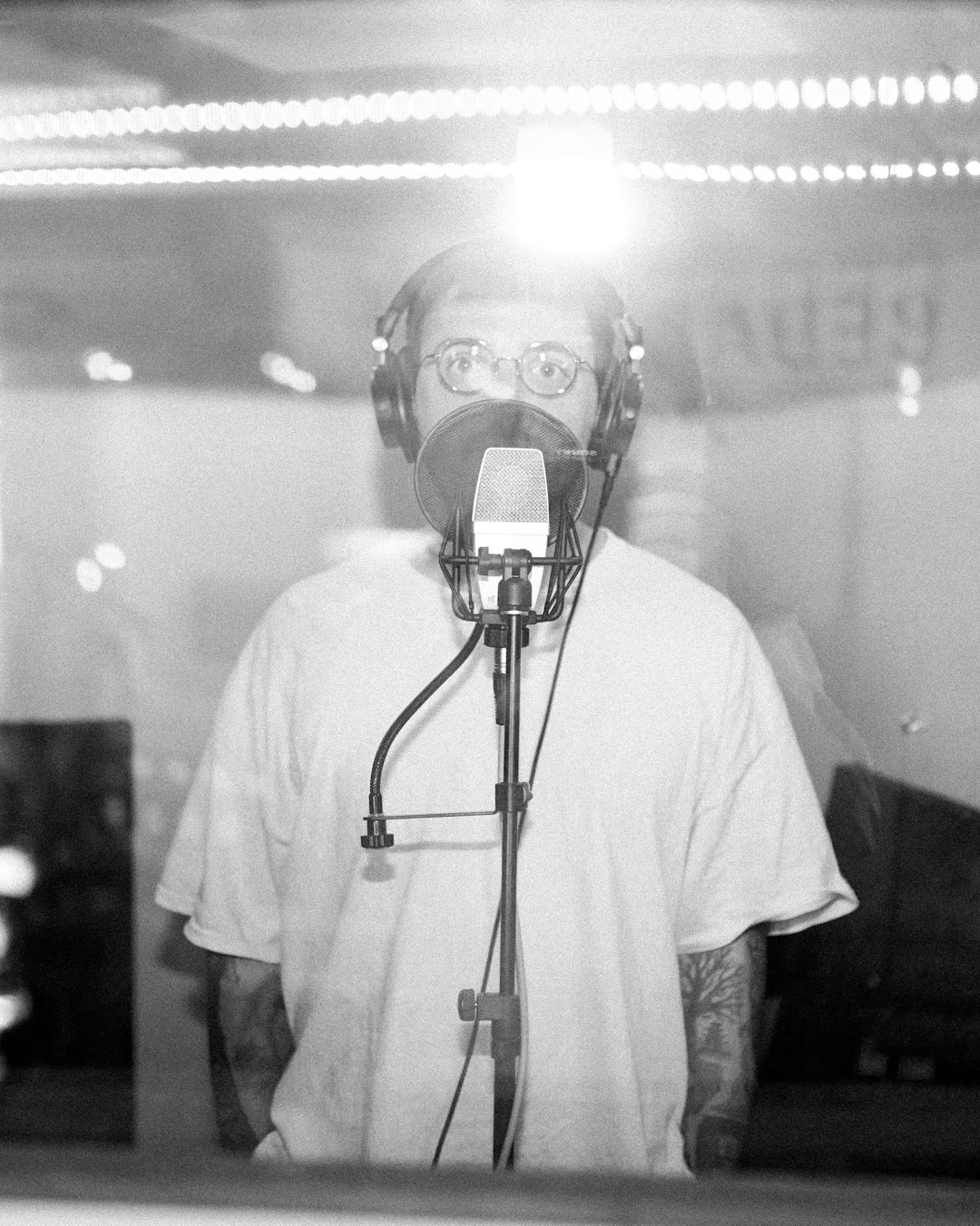 Studio portrait of a Belgian radio journalist with glasses and a beard