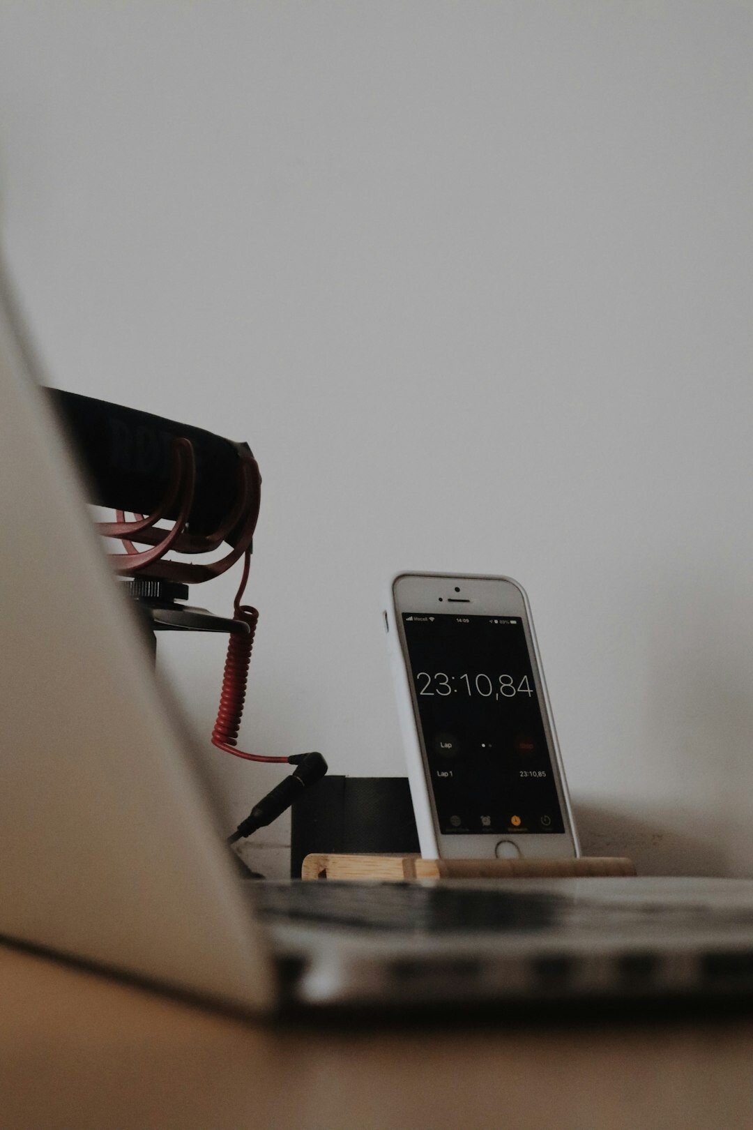 Close-up of a journalist's desk with a microphone, notebook and audio recorder