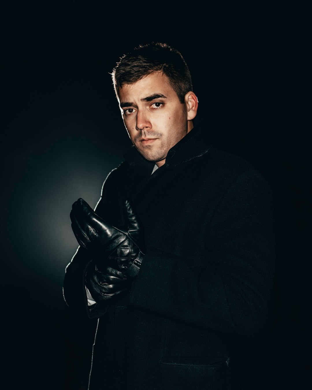 Studio portrait of a Belgian-Congolese investigative journalist in a suit